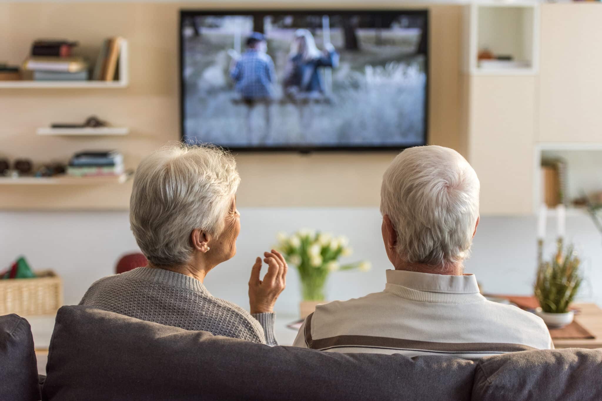 Couple watching television together.