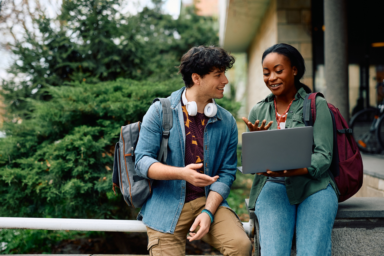 College students reviewing their notes on a laptop