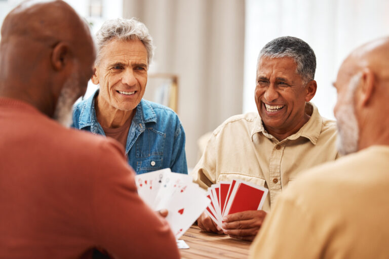 A group of senior men hanging out, playing cards