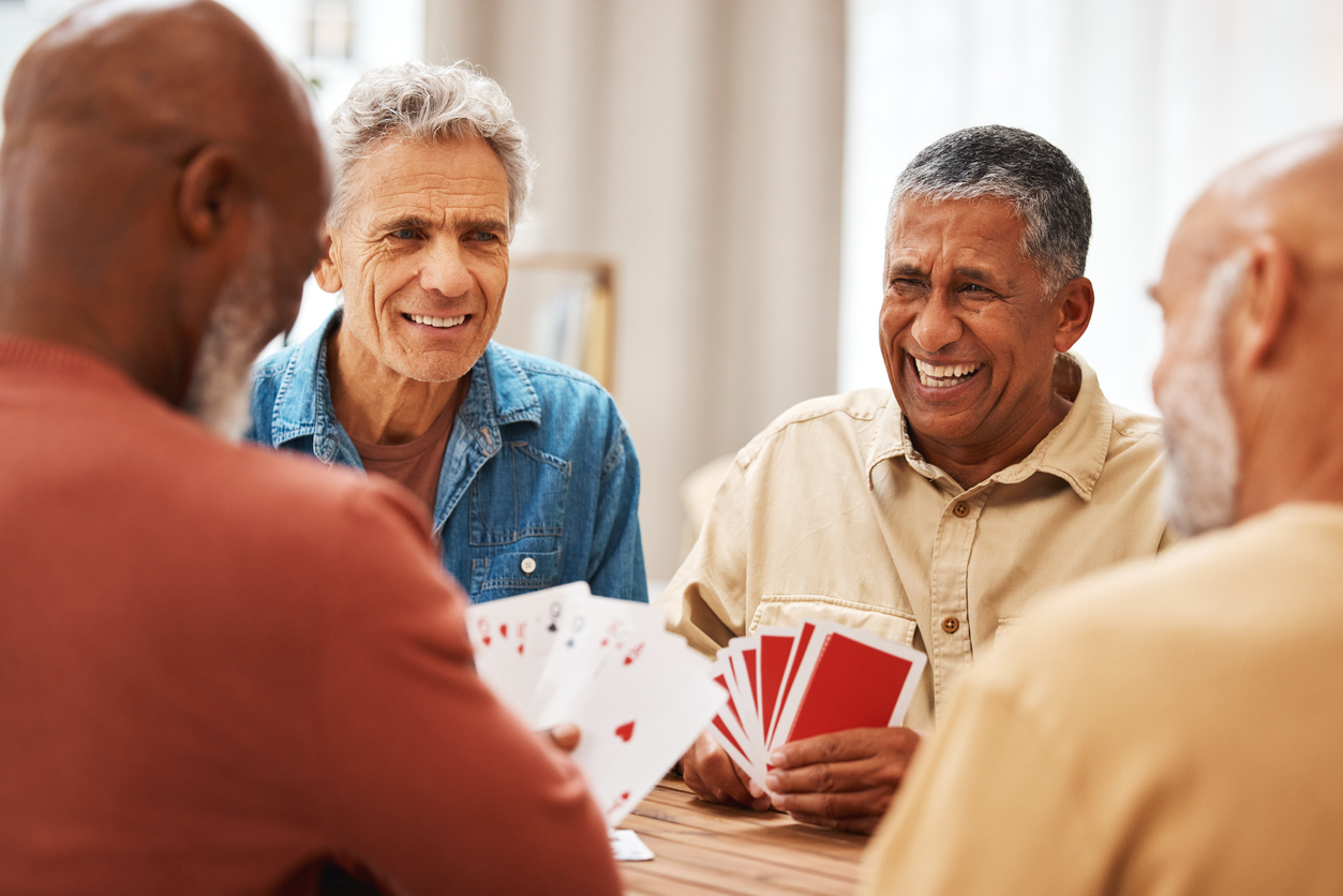 A group of senior men hanging out, playing cards