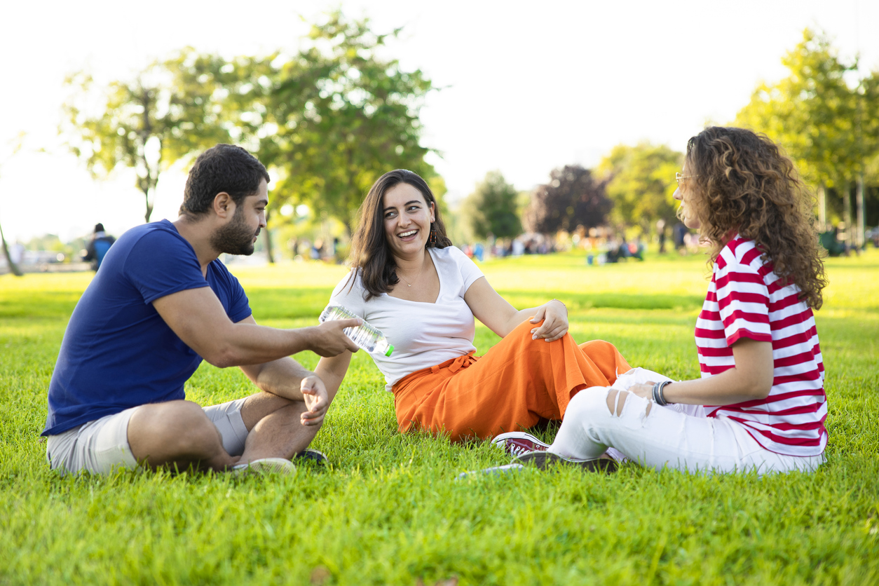 Three friends talking in the park