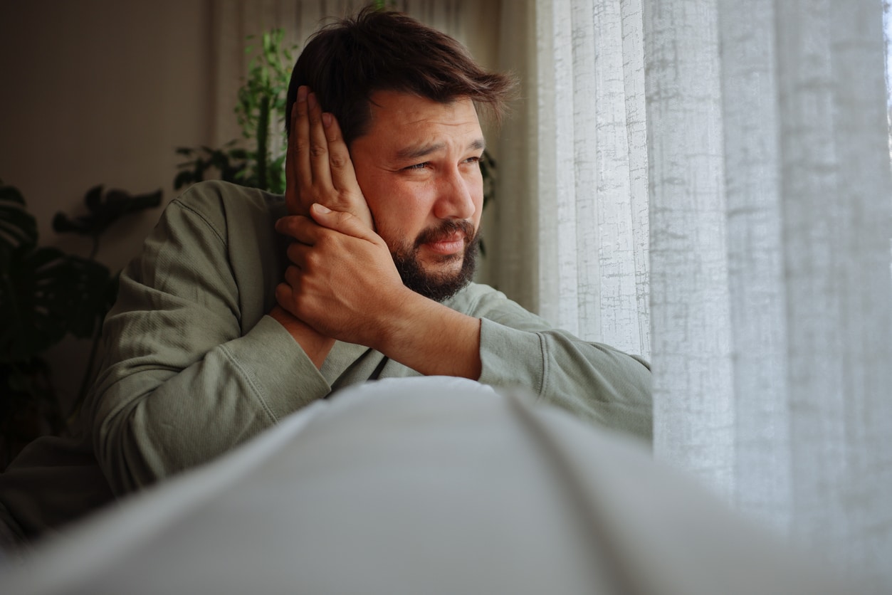 A man with a concussion dealing with temporary hearing loss.
